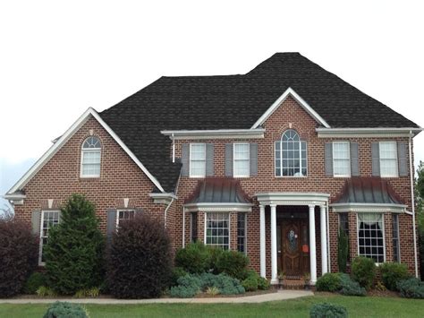 charcoal metal roof on red brick house|black roof color for brick house.